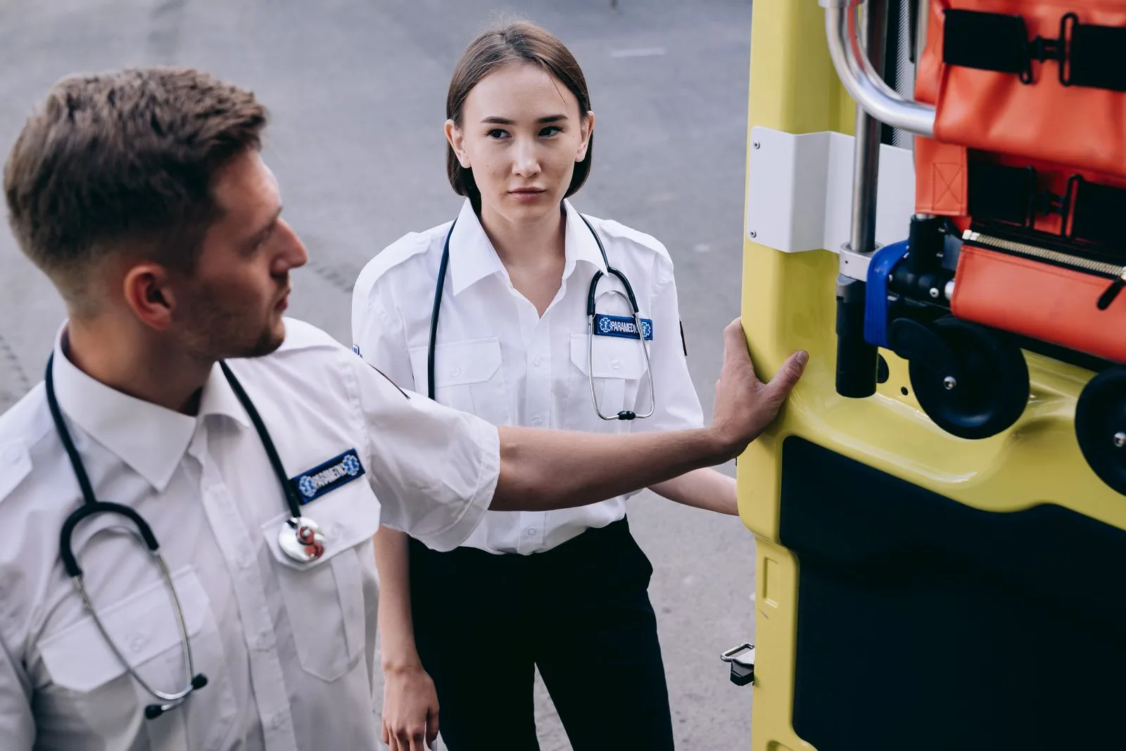 A pair of paramedics with stethoscopes draped around their necks