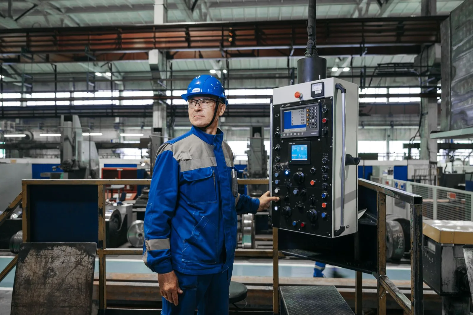 Industrial worker operating machinery on a factory floor