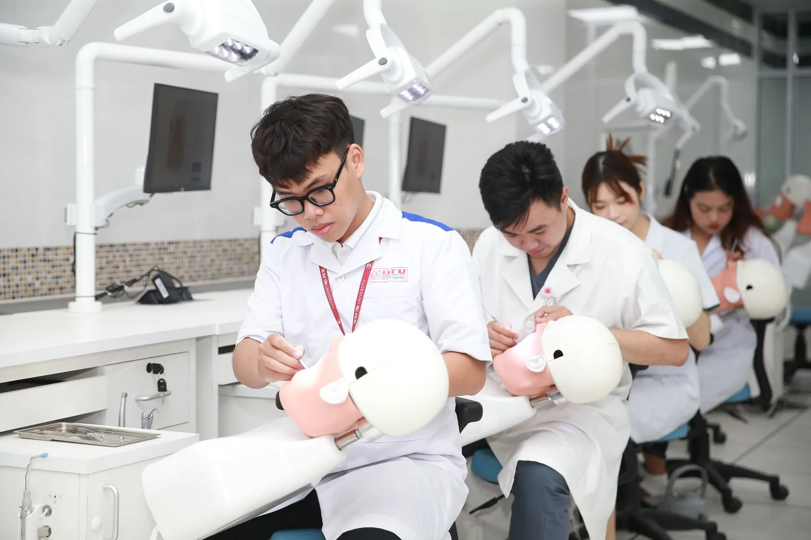 Dental students practicing procedures with training mannequins