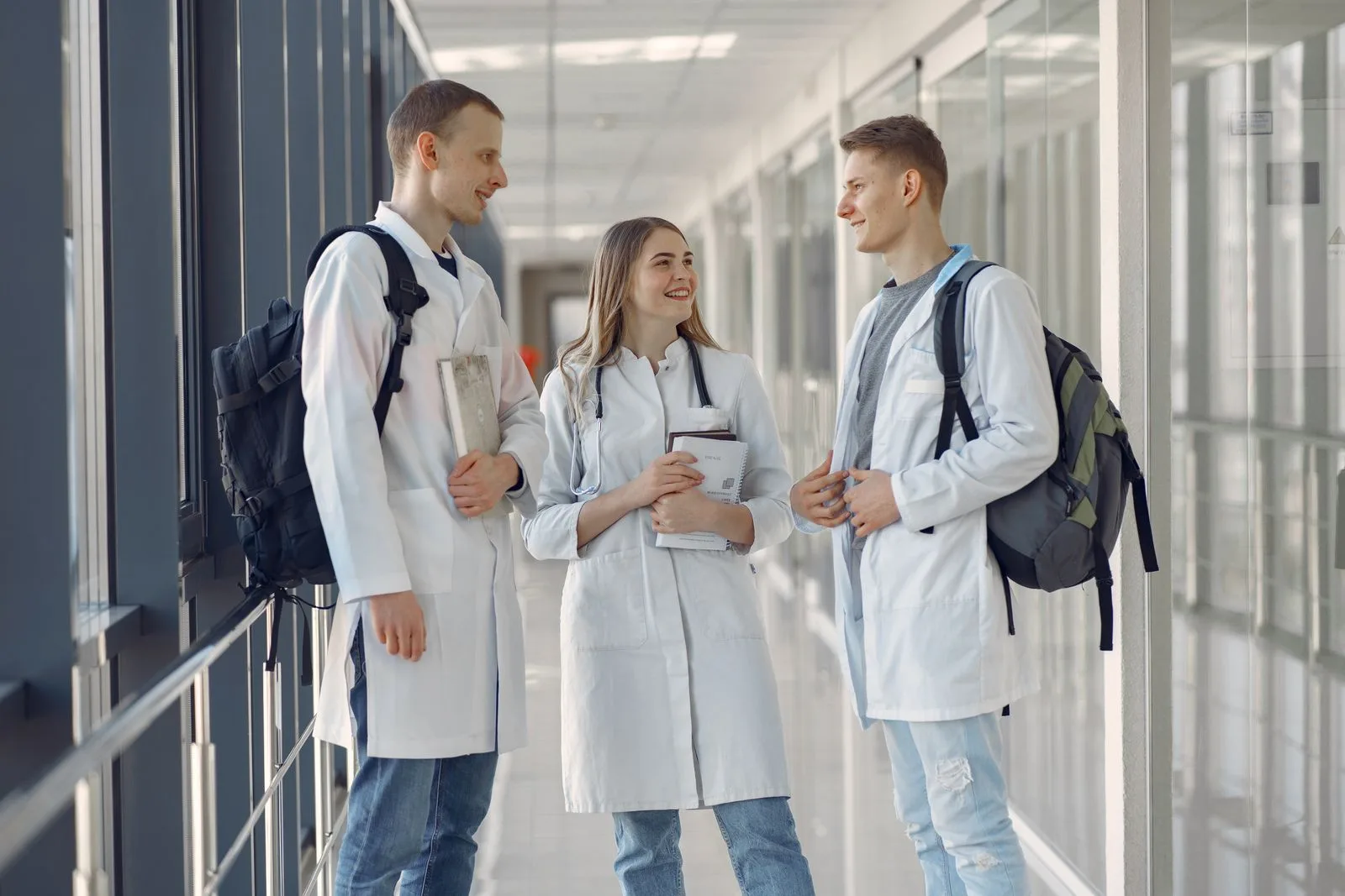 A group of medical students training together in a hospital hallway