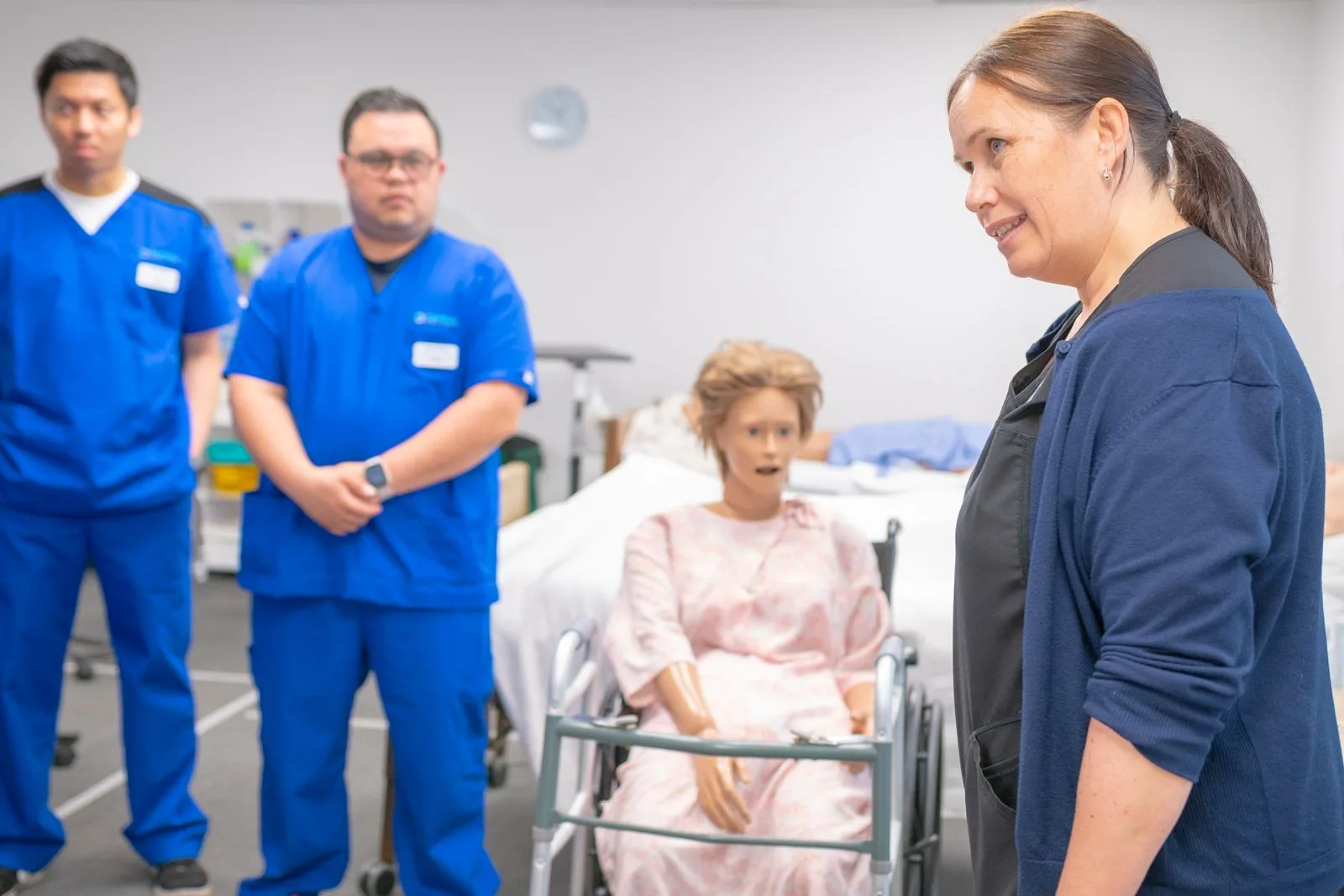 Nursing students in clinical training with a mannequin