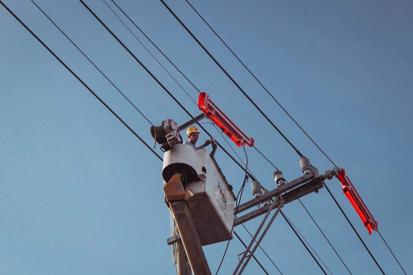 Electrician repairing an electrical post