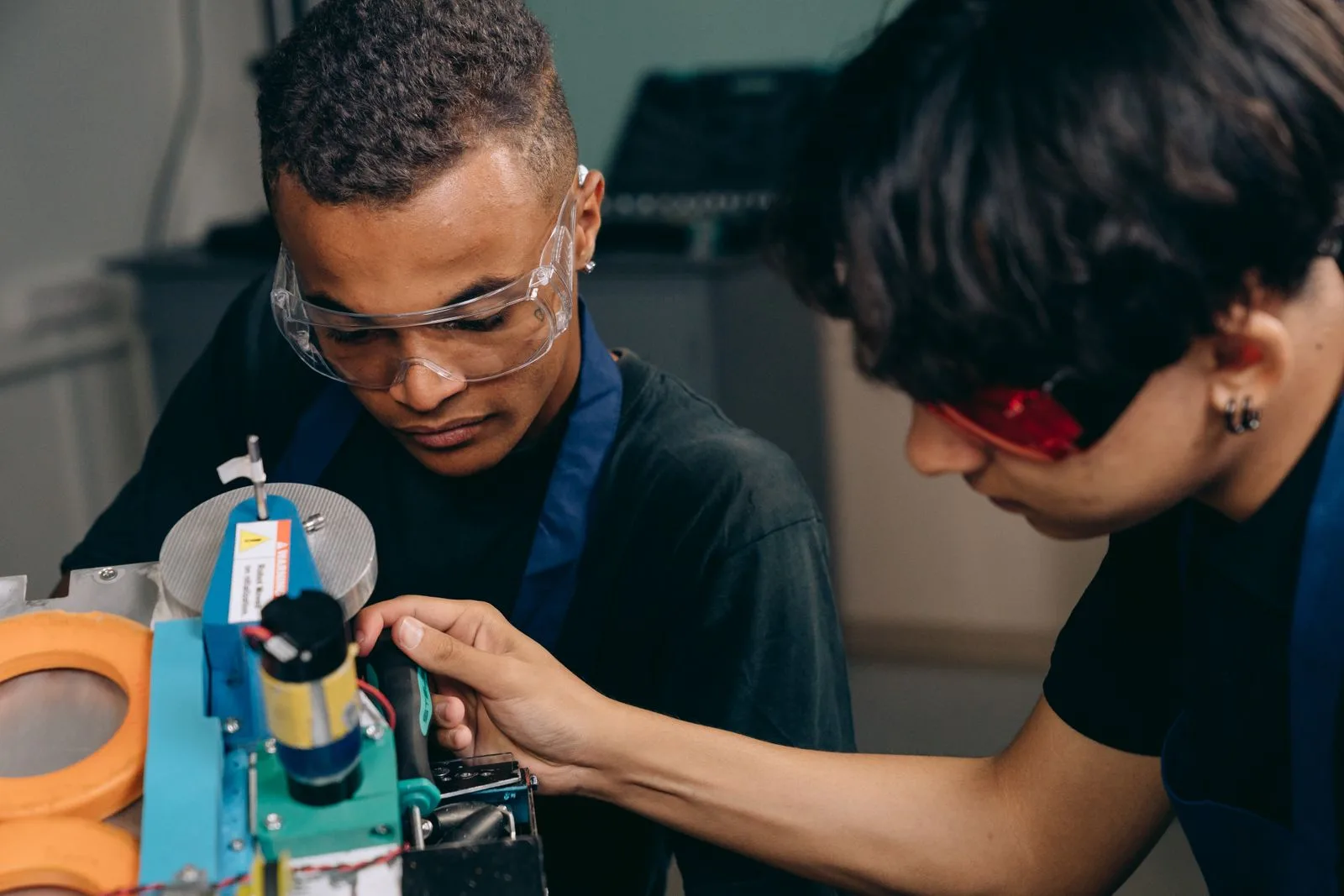 Workers assembling robotics equipment in a manufacturing workshop