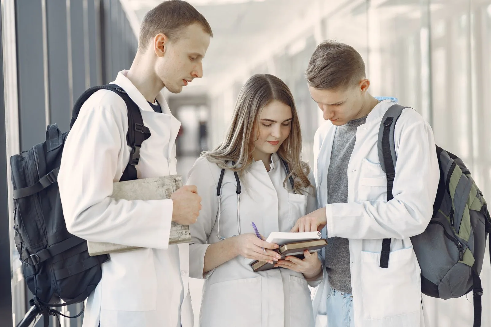 A group of medical students training together in a hospital hallway