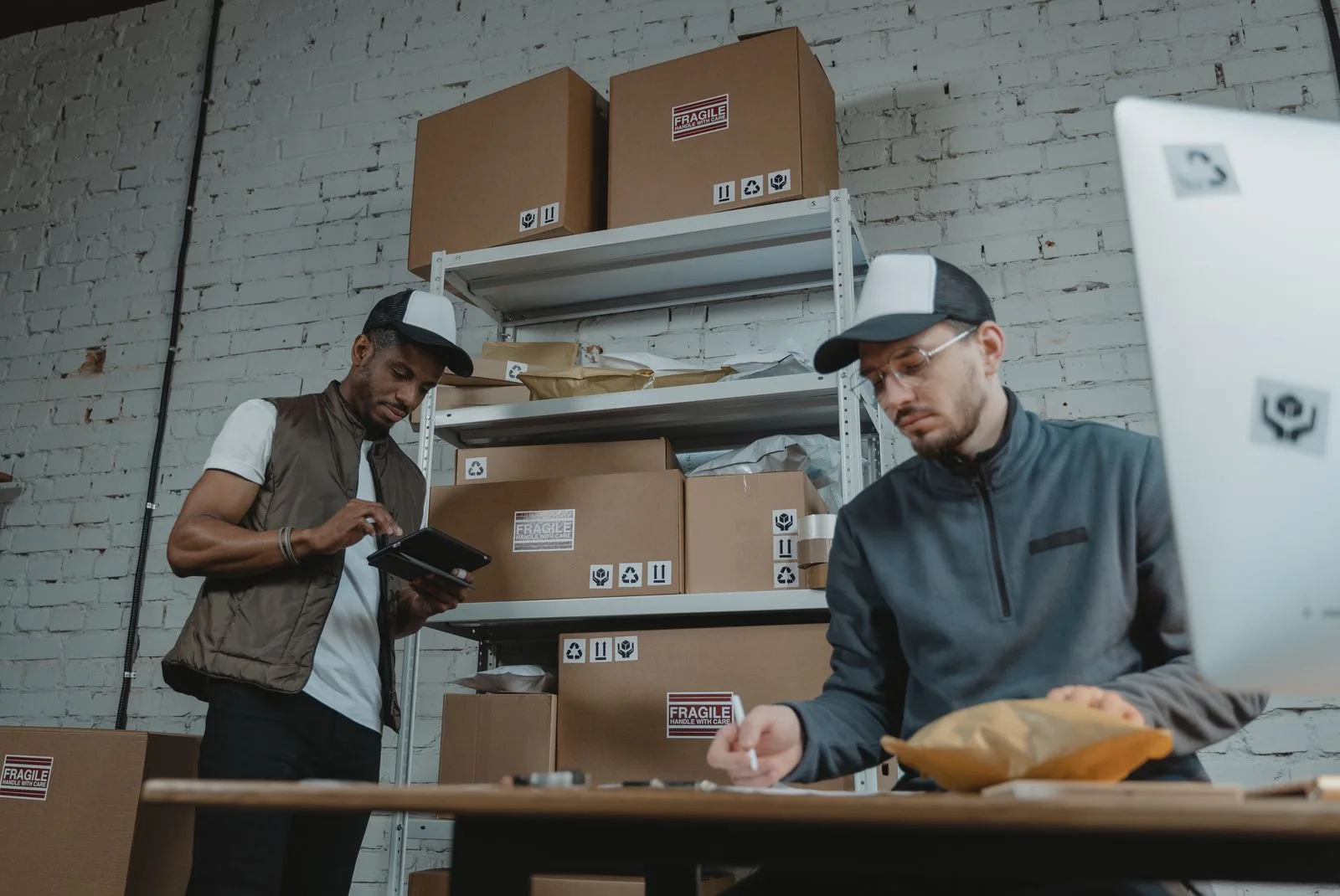Two warehouse employees talking on the floor